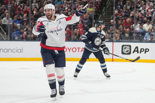 Washington Capitals right wing Tom Wilson celebrates a goal by teammate John Carlson in front of Columbus Blue Jackets defenseman Zach Werenski, right, in the second period of an NHL hockey game Friday, Oct. 24, 2025, in Columbus, Ohio. (AP Photo/Sue Ogrocki) Washington Capitals right wing Tom Wilson celebrates a goal by teammate John Carlson in front of Columbus Blue Jackets defenseman Zach Werenski, right, in the second period of an NHL hockey game Friday, Oct. 24, 2025, in Columbus, Ohio. (AP Photo/Sue Ogrocki)