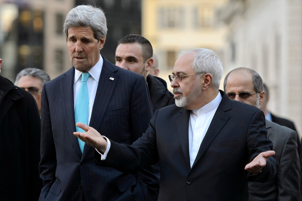 FILE - U.S. Secretary of State John Kerry, left, listens to Iranian Foreign Minister Mohammad Javad Zarif as they walk in the city of Geneva, Switzerland, Jan. 14, 2015, during a bilateral meeting ahead of the next round of nuclear discussions. (Martial Trezzini/Keystone via AP, File)