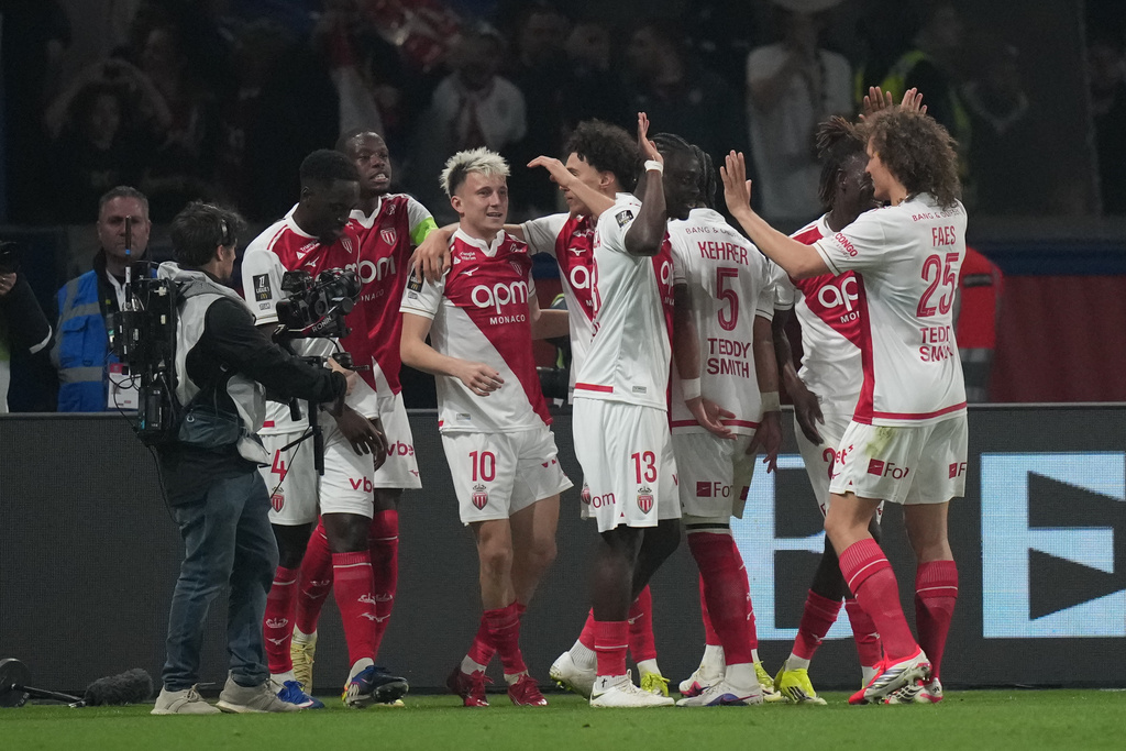 Monaco's Aleksandr Golovin (10) is congratulated after scoring his side's 2nd goal during the French League One soccer match between Paris Saint-Germain and Monaco in Paris, Friday, March 6, 2026. (AP Photo/Thibault Camus)