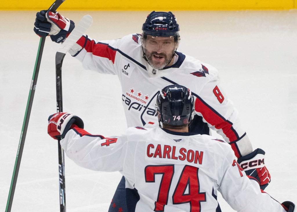 Washington Capitals' Alex Ovechkin (8) celebrates his goal over the Montreal Canadiens with teammate John Carlson (74) during first period NHL hockey action in Montreal on Thursday, Nov. 20, 2025. (Christinne Muschi/The Canadian Press via AP)