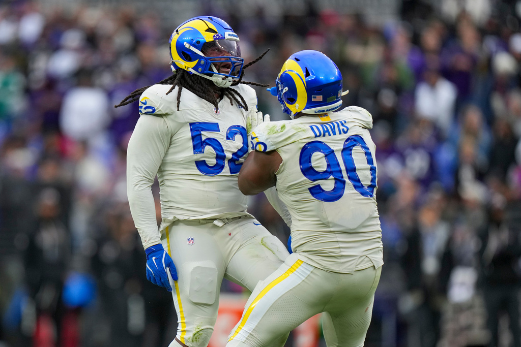 Los Angeles Rams defensive end Larrell Murchison (52) reacts with defensive end Tyler Davis (90) after a play against the Baltimore Ravens during the second half of an NFL football game Sunday, Oct. 12, 2025, in Baltimore. (AP Photo/Stephanie Scarbrough)