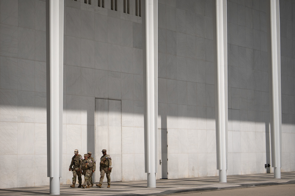 National Guard members walk outside of the Kennedy Center, Friday, July 31, 2026, in Washington. (AP Photo/Mark Schiefelbein)