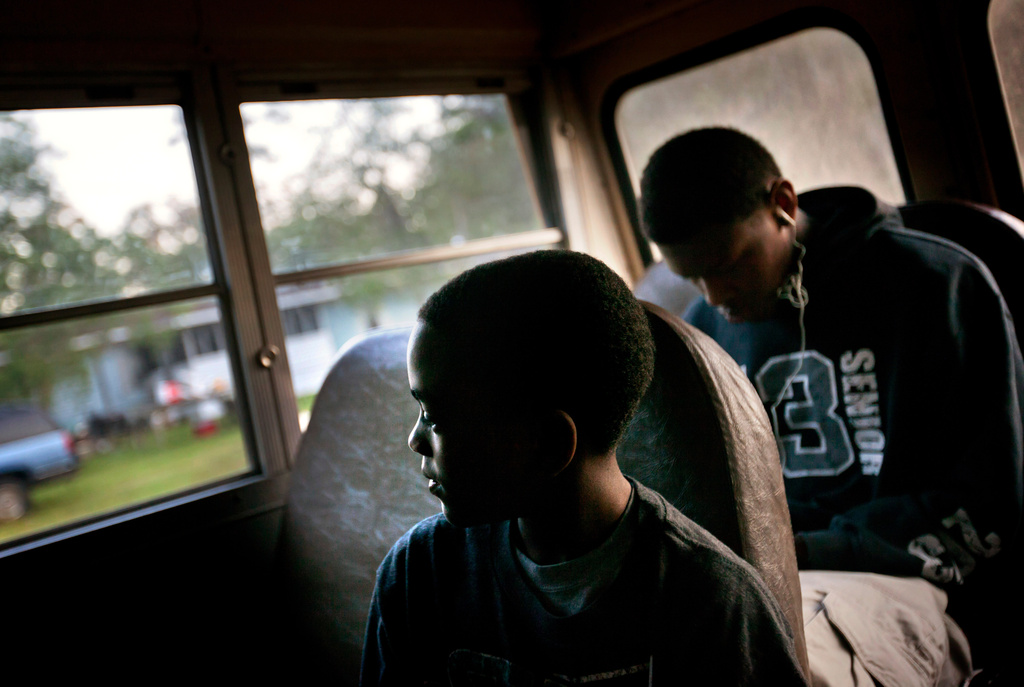 FILE - J.J. Wilson, 9, rides a school bus to catch a ferry to the his school on the mainland from his home in the Hog Hammock community of Sapelo Island, Ga., on Wednesday, May 15, 2013. (AP Photo/David Goldman, File)
