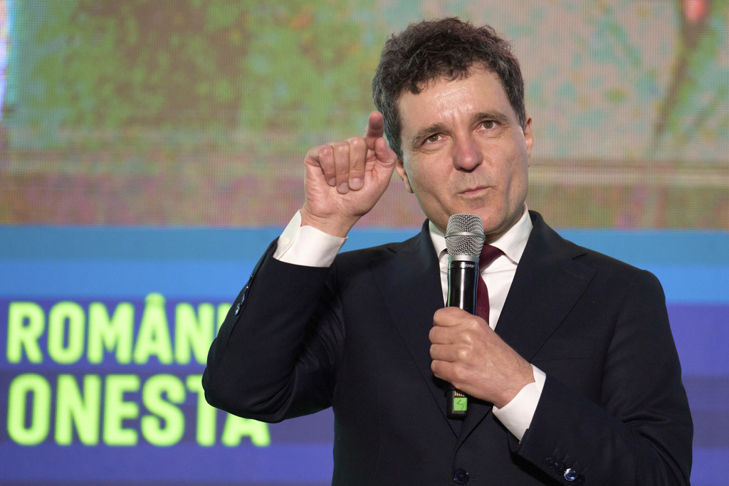 Presidential candidate Nicusor Dan gestures during an electoral rally, a week ahead of the second round of the country's presidential election redo in Bucharest, Romania, Sunday, May 11, 2025. (AP Photo/Vadim Ghirda)