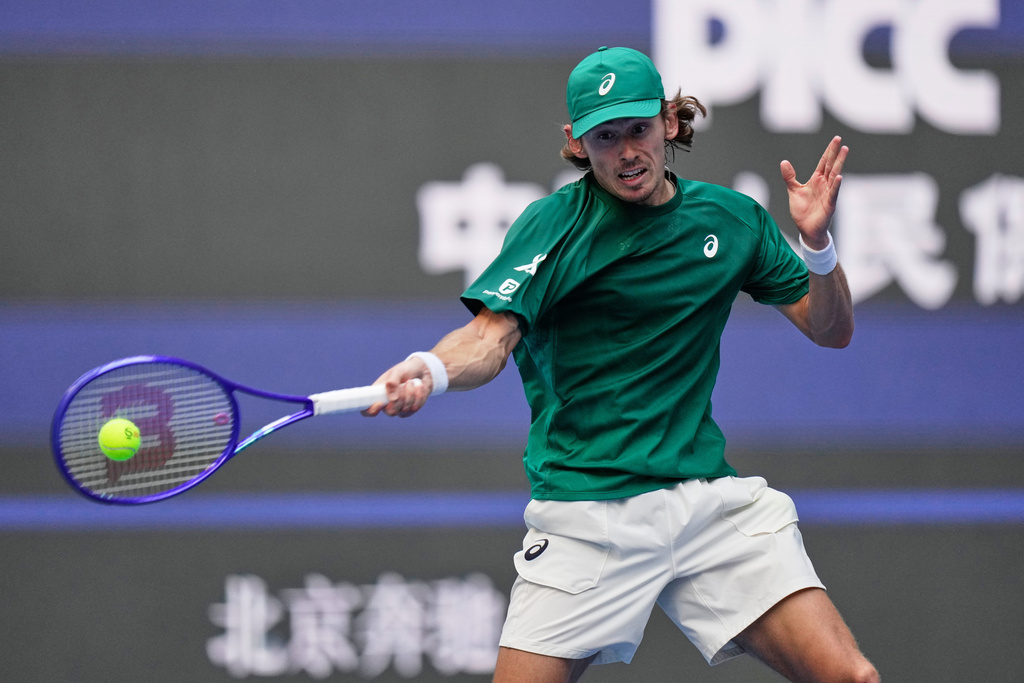 Alex De Minaur of Australia returns a forehand shot to Jannik Sinner of Italy during the men's singles semifinal match for the China Open tennis tournament, in Beijing, China, Tuesday, Sept. 30, 2025. (AP Photo/Mahesh Kumar A.)