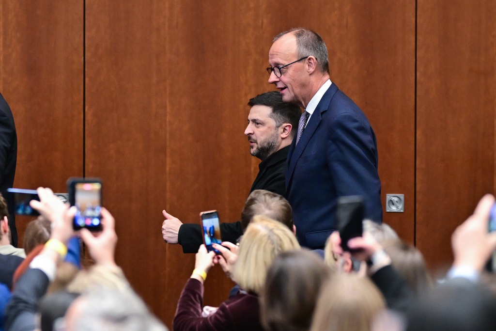 Ukraine's President Volodymyr Zelenskyy, center left, and German Chancellor Friedrich Merz, center right, attend the German-Ukrainian Economic Forum in Berlin, Germany, Monday, Dec. 15, 2025. (Sebastian Christoph Gollnow/dpa via AP)
