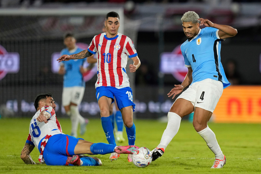 FILE - Uruguay's Ronald Araujo, right, and Paraguay's Diego Gomez battle for the ball during a qualifying soccer match for the FIFA World Cup 2026 in Asuncion, Paraguay, Thursday, June 5, 2025. (AP Photo/Jorge Saenz, File)