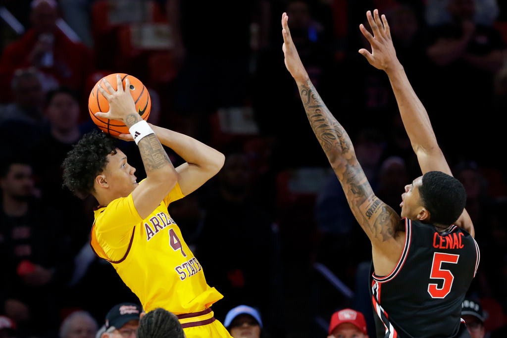 Arizona State guard Bryce Ford (4) shoots as Houston center Chris Cenac Jr. (5) defends during the first half of an NCAA college basketball game Sunday, Jan. 18, 2026, in Houston. (AP Photo/Michael Wyke)