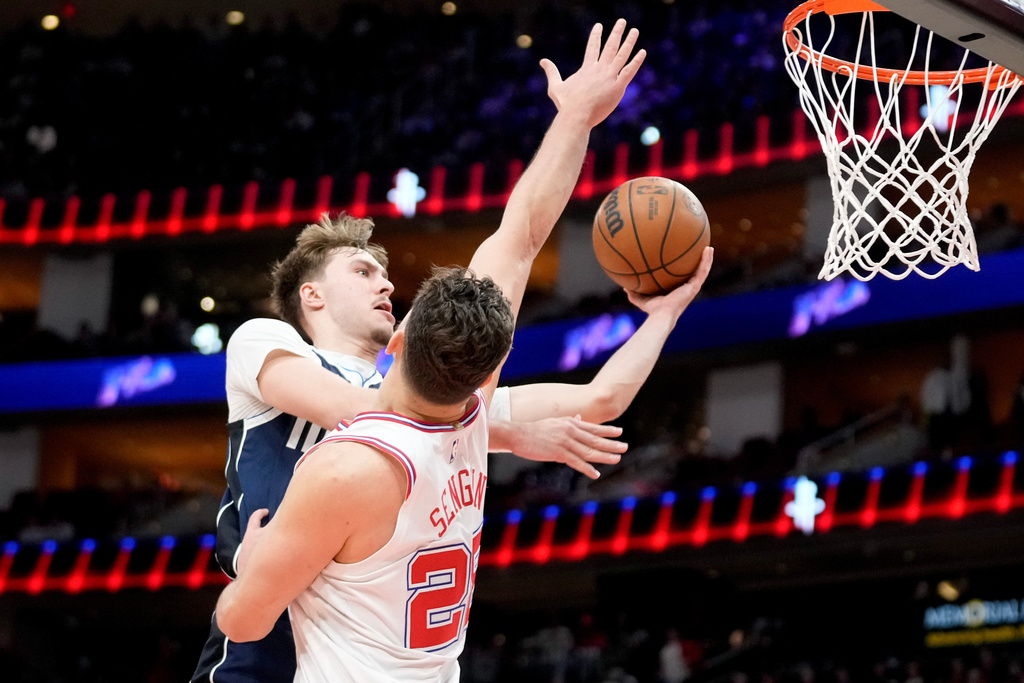 Dallas Mavericks forward Cooper Flagg, left, drives to the basket as Houston Rockets center Alperen Sengun, right, defends during the first half of an NBA basketball game Saturday, Jan. 31, 2026, in Houston. (AP Photo/Eric Christian Smith)