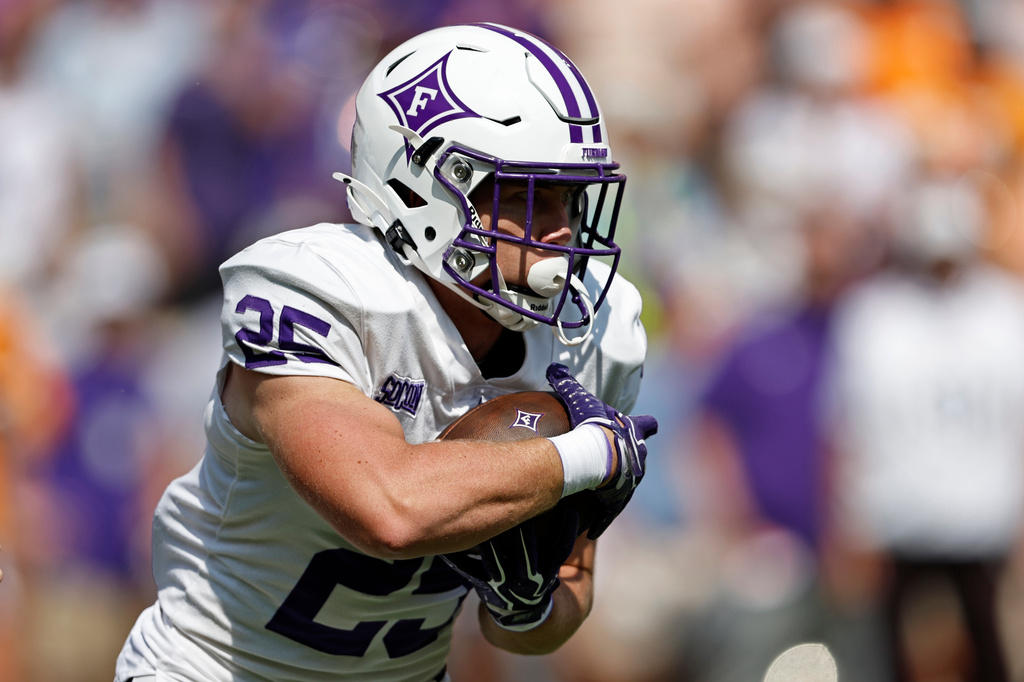 Furman running back Ben Croasdale (25) runs for yardage during the first half of an NCAA college football game against Tennessee, Saturday, Sept. 5, 2026, in Knoxville, Tenn. (AP Photo/Wade Payne)