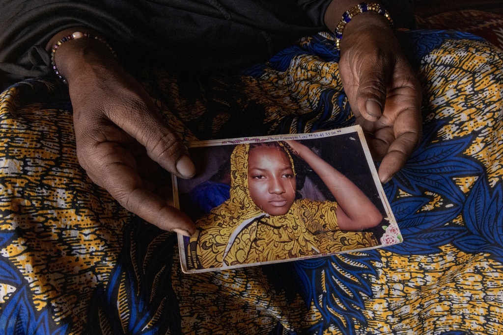 Fatma holds a photo of her daughter, who died when they fled their village, in Mali in Douankara, Hodh El Chargui Region, Mauritania where they found refuge, Nov. 6, 2025. (AP Photo/Caitlin Kelly)