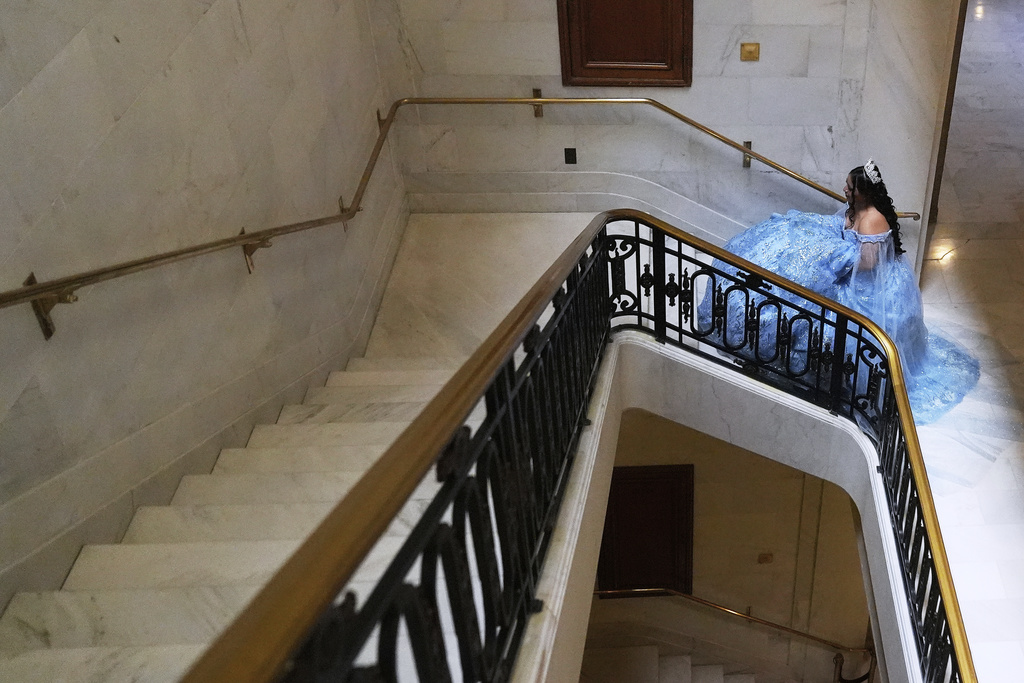 Abbie Gonzalez walks up the stairs during her quinceañera portrait session at City Hall in San Francisco, Monday, Aug. 25, 2025. (AP Photo/Jeff Chiu)