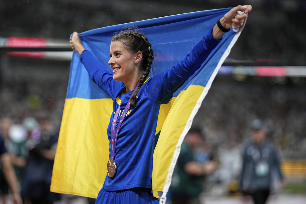 Ukraine's Yaroslava Mahuchikh celebrates taking the bronze in the women's high jump final at the World Athletics Championships in Tokyo, Sunday, Sept. 21, 2025. (AP Photo/Louise Delmotte)