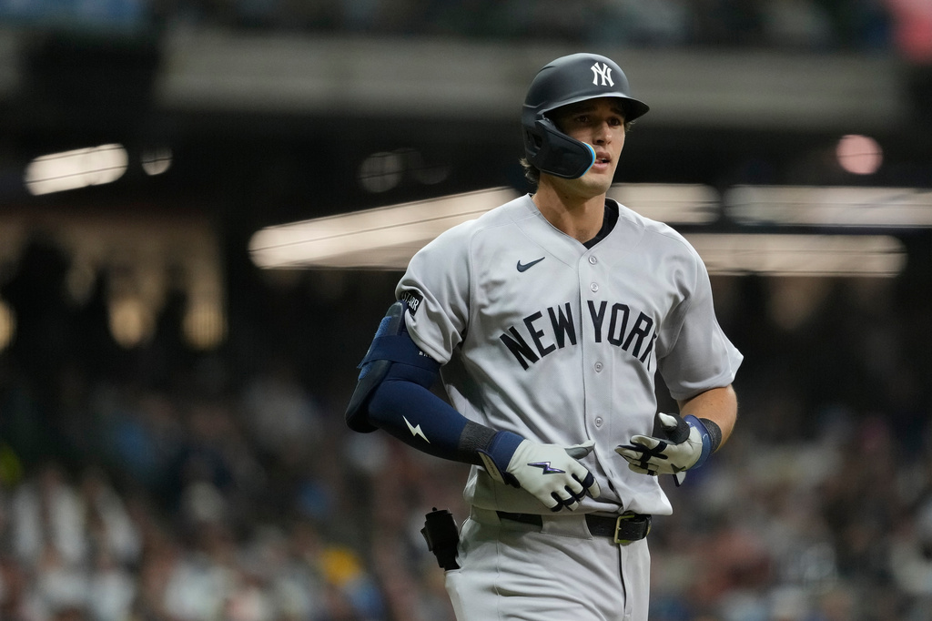 New York Yankees' Spencer Jones jogs to first base after drawing a walk during the fifth inning of a baseball game against the Milwaukee Brewers, Friday, May 8, 2026, in Milwaukee. (AP Photo/Aaron Gash)