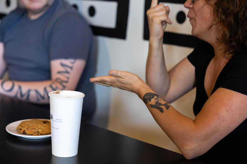People attending a weekly meet up called "Sign Squad" communicate in American Sign Language at the Woodstock Cafe on June 10, 2025, in Portland, Ore. (Allison Barr/The Oregonian via AP)