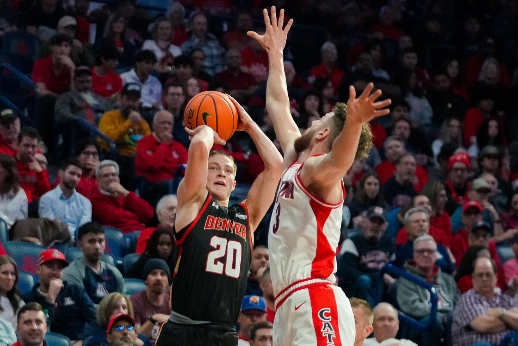Denver Pioneers guard Carson Johnson (20) shoot against Arizona Wildcats guard Anthony Dell'Orso (3) during the first half of an NCAA college basketball game, Monday, Nov. 24, 2025, in Tucson, Ariz. (AP Photo/Darryl Webb)