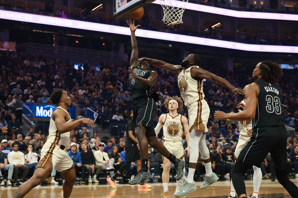 Brooklyn Nets guard Drake Powell (4) shoots against Golden State Warriors forward Draymond Green (23) during the first half of an NBA basketball game in San Francisco, Wednesday, March 25, 2026. (AP Photo/Jed Jacobsohn)