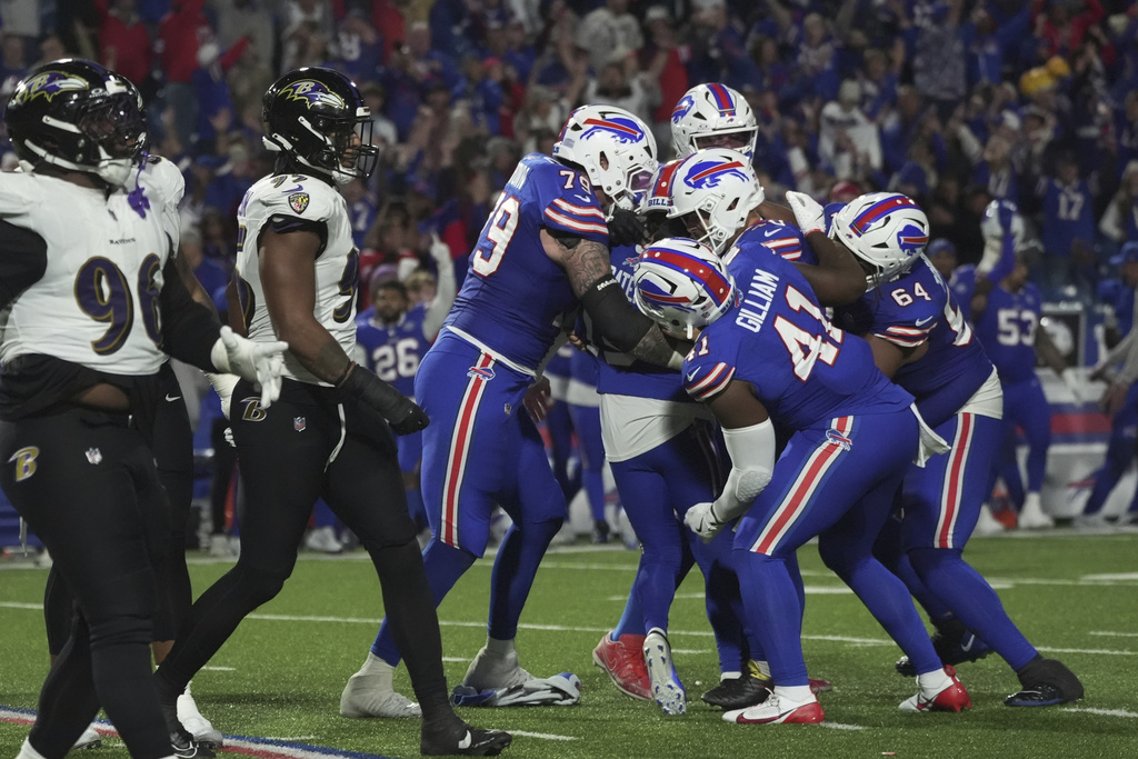 Buffalo Bills kicker Matt Prater (15) is swarmed by teammates after his game-winning field goal against the Baltimore Ravens during the second half of an NFL football game in Orchard Park, N.Y., Sunday, Sept. 7, 2025. (AP Photo/Gene J. Puskar)
