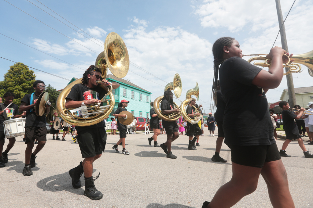 People participate in Juneteenth celebrations on Ball Avenue in Galveston, Texas, on Friday, June 19, 2026. (AP Photo/Lekan Oyekanmi)