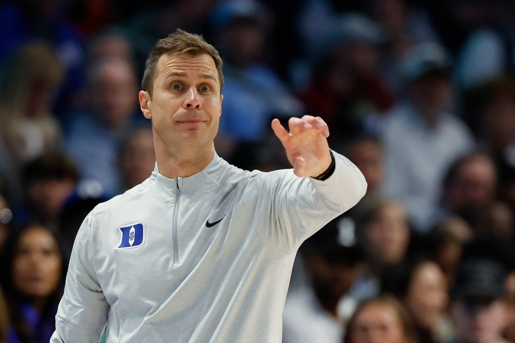 Duke head coach Jon Scheyer directs his team against Florida State during the second half of an NCAA college basketball game in the quarterfinals of the Atlantic Coast Conference tournament in Charlotte, N.C., Thursday, March 12, 2026. (AP Photo/Nell Redmond)