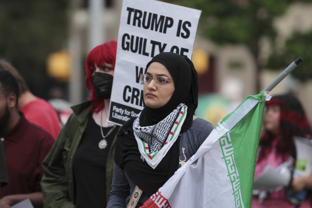 Zainab Haider holds a flag during a protest against the Iran war on Wednesday, April 8, 2026, in Austin, Texas. (Brianna Griffith via AP)