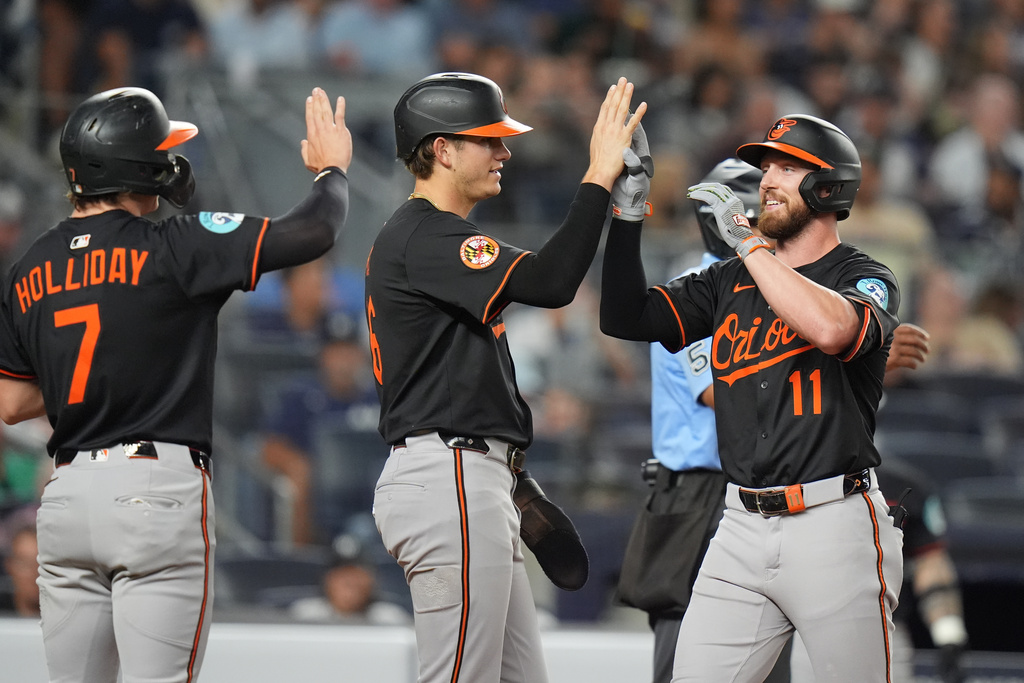 Baltimore Orioles' Jordan Westburg (11) celebrates with Coby Mayo and Jackson Holliday (7) after hitting a three-run home run during the third inning of a baseball game against the New York Yankees Friday, Sept. 26, 2025, in New York. (AP Photo/Frank Franklin II)