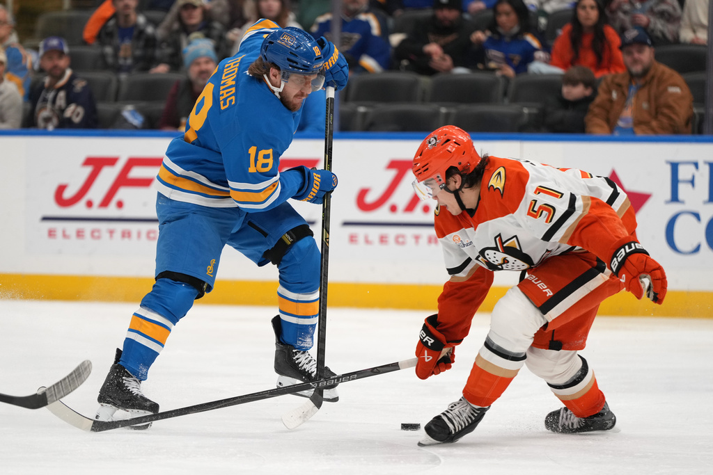 St. Louis Blues' Robert Thomas passes around Anaheim Ducks' Olen Zellweger (51) during the second period of an NHL hockey game Monday, Dec. 1, 2025, in St. Louis. (AP Photo/Jeff Roberson)