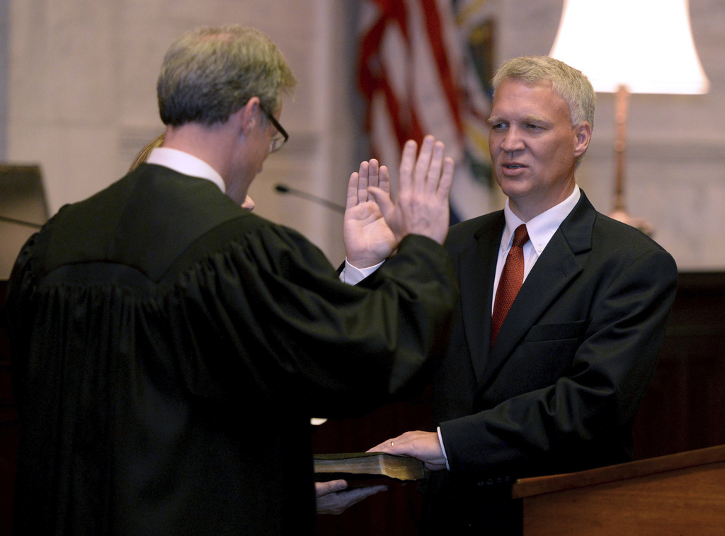 FILE - Tim Armstead, right, former speaker of the West Virginia House of Delegates, is sworn in as a state Supreme Court justice by his former House chief of staff, Kanawha Circuit Judge Dan Greear, in the court's chamber at the state Capitol in Charleston, W.Va., Sept. 25, 2018. (Chris Dorst/Charleston Gazette-Mail via AP, File)