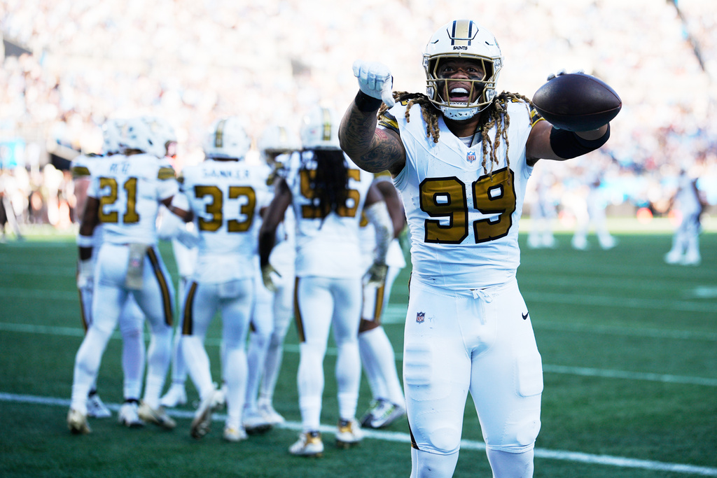 New Orleans Saints defensive end Chase Young celebrates after cornerback Alontae Taylor intercepts a pass intended for Carolina Panthers wide receiver Tetairoa McMillan during the second half of an NFL football game, Sunday, Nov. 9, 2025, in Charlotte, N.C. (AP Photo/Jacob Kupferman)