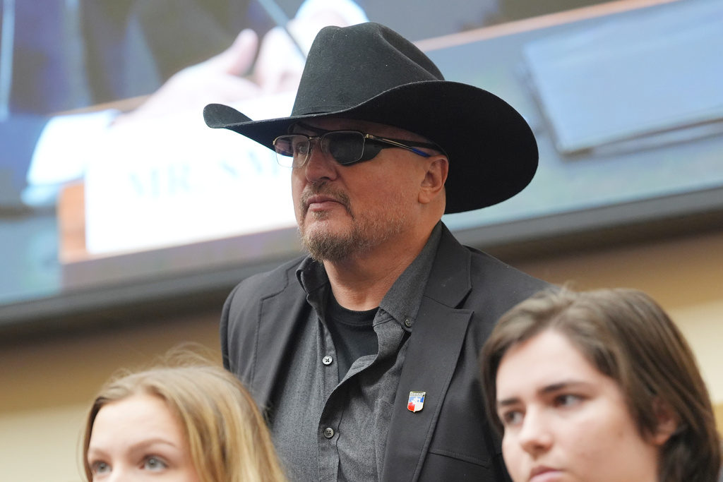 Founder of the Oath Keepers Stewart Rhodes, center, taking his seat for the testimony of former Justice Department special counsel Jack Smith before the House Judiciary Committee about his investigations into President Donald Trump, Thursday, Jan. 22, 2026 at the Capitol in Washington. (AP Photo/Jacquelyn Martin)