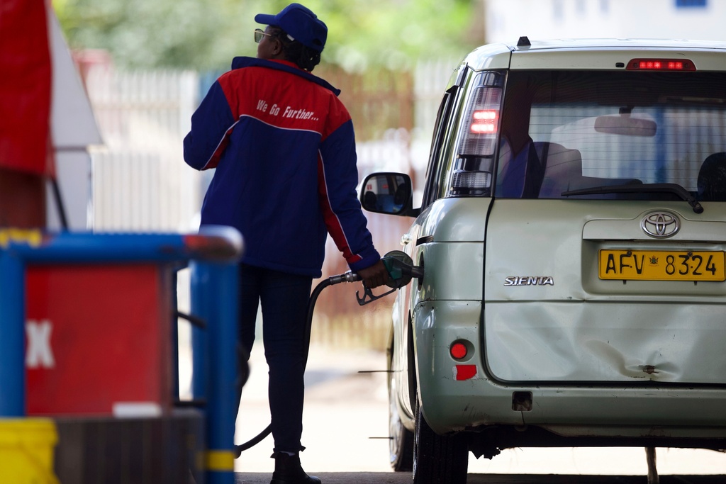 A service station worker fills a car's tank with gasoline in Harare, Thursday, March 5, 2026. (AP Photo/Wonder Mashura)