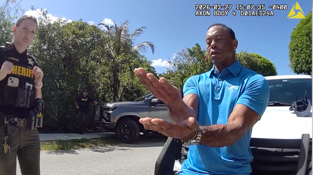 In this image from police body camera video released by the Martin County, Fla., Sheriff's Office, golfer Tiger Woods performs a field sobriety test for sheriff's deputies following a car crash in Jupiter Island, Fla., Friday, March 27, 2026. (Martin County Sheriff's Office via AP)