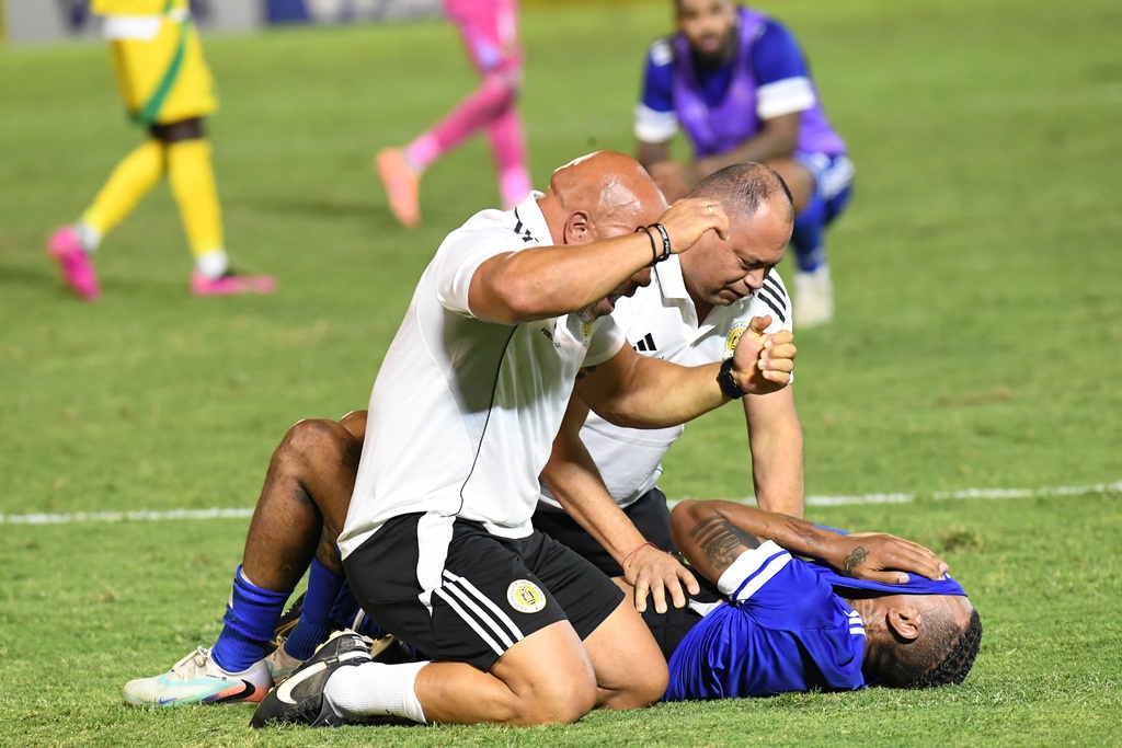 Curacao players and trainers celebrate qualifying for the 2026 FIFA World Cup after their game with Jamaica in Kingston, Jamaica, Tuesday, Nov. 18, 2025. (AP Photo/Collin Reid)