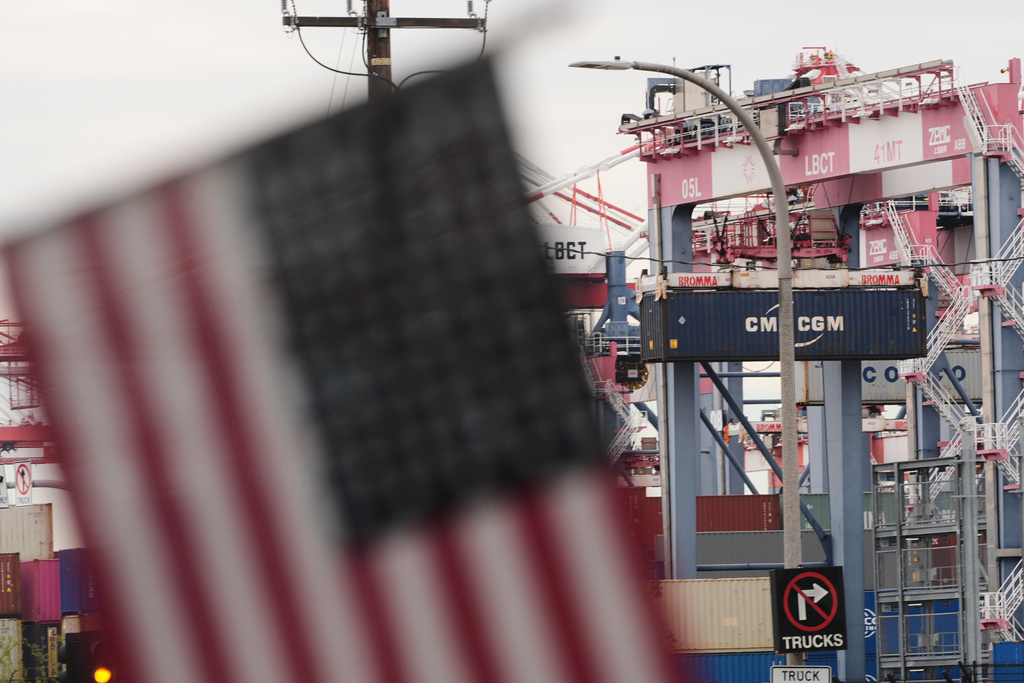 A U.S. flag files at the Port of Long Beach Friday, Feb. 20, 2026, in Long Beach, Calif. (AP Photo/Damian Dovarganes)