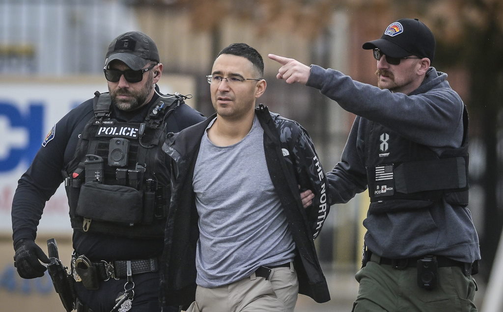 FILE - Solomon Pena, center, a Republican candidate for New Mexico House District 14, is taken into custody by Albuquerque Police officers, Jan. 16, 2023, in southwest Albuquerque, N.M. (Roberto E. Rosales/The Albuquerque Journal via AP, File)