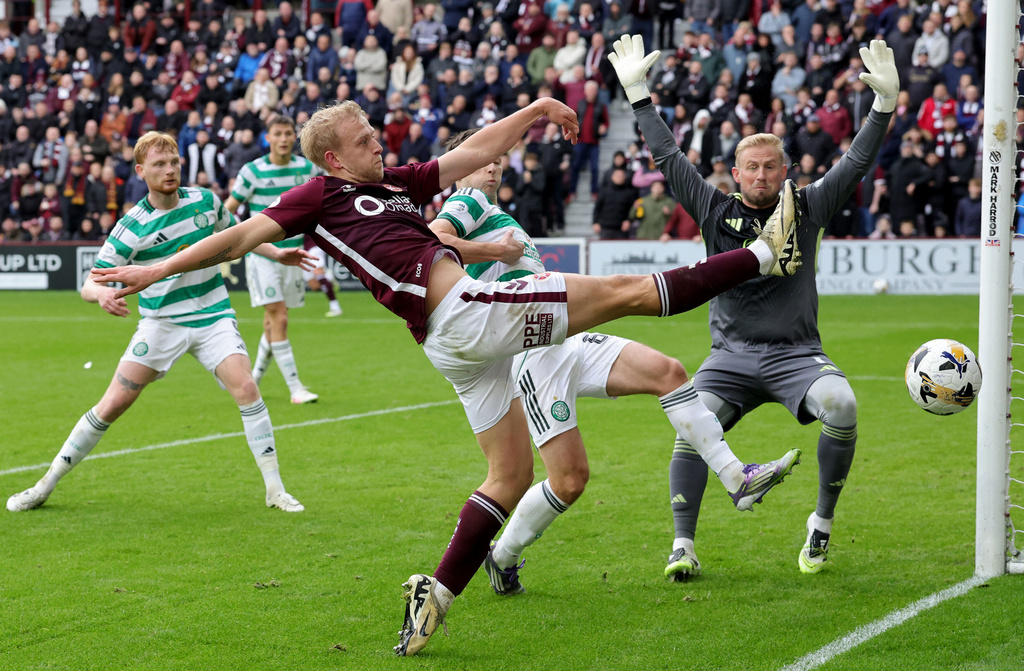Heart of Midlothian's Harry Milne has a shot on goal during the Scottish Premiership soccer match between Heart of Midlothian and Celtic, at Tynecastle Park, in Edinburgh, Sunday, Oct. 26, 2025. (Steve Welsh/PA via AP)