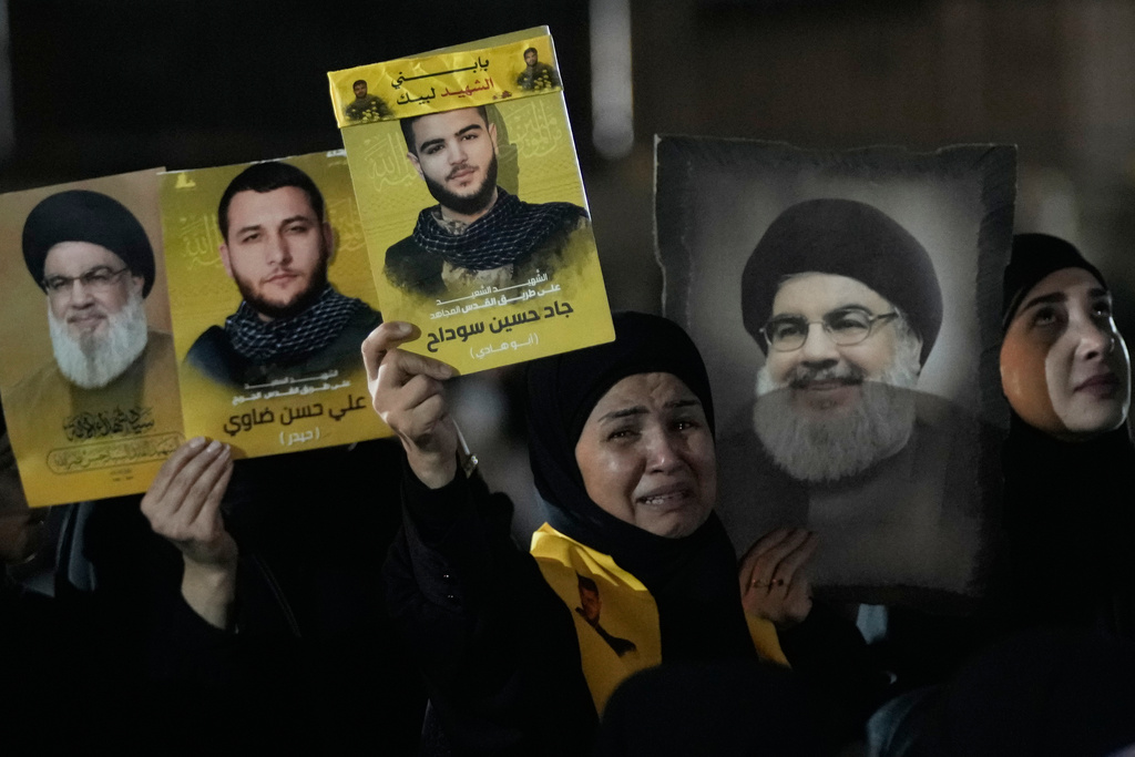 CORRECTS MONTH: People gather at the site where Hezbollah leader Hassan Nasrallah was killed in Israeli airstrikes on Sept. 27, 2024, a day before the first anniversary of his death, in the Haret Hreik suburb south of Beirut, Lebanon, Friday, Sept. 26, 2025. (AP Photo/Hassan Ammar)