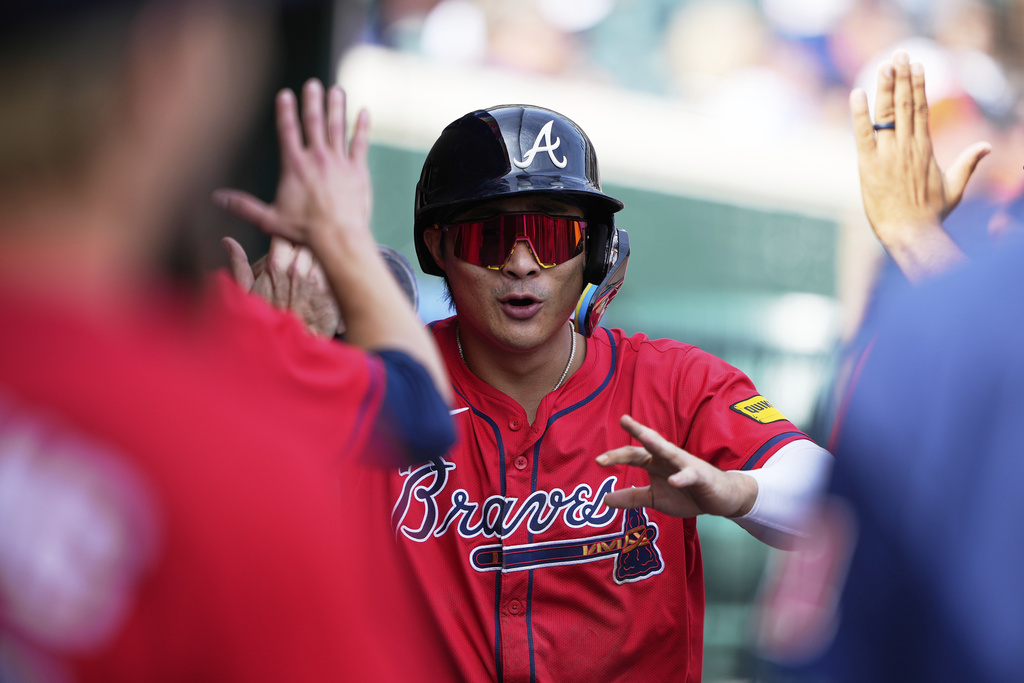 Atlanta Braves' Ha-Seong Kim celebrates in the dugout after scoring the go-ahead run off a single hit by Jurickson Profar during the ninth inning of a baseball game against the Detroit Tigers, Saturday, Sept. 20, 2025, in Detroit. (AP Photo/Ryan Sun)