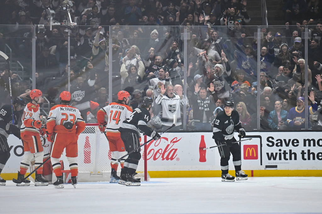 Los Angeles Kings left wing Trevor Moore (12) skates after scoring a goal as Los Angeles Kings right wing Alex Laferriere (14), left, follows during the first period of an NHL hockey game against the Anaheim Ducks, Saturday, Dec. 27, 2025, in Los Angeles. (AP Photo/Katie Chin)