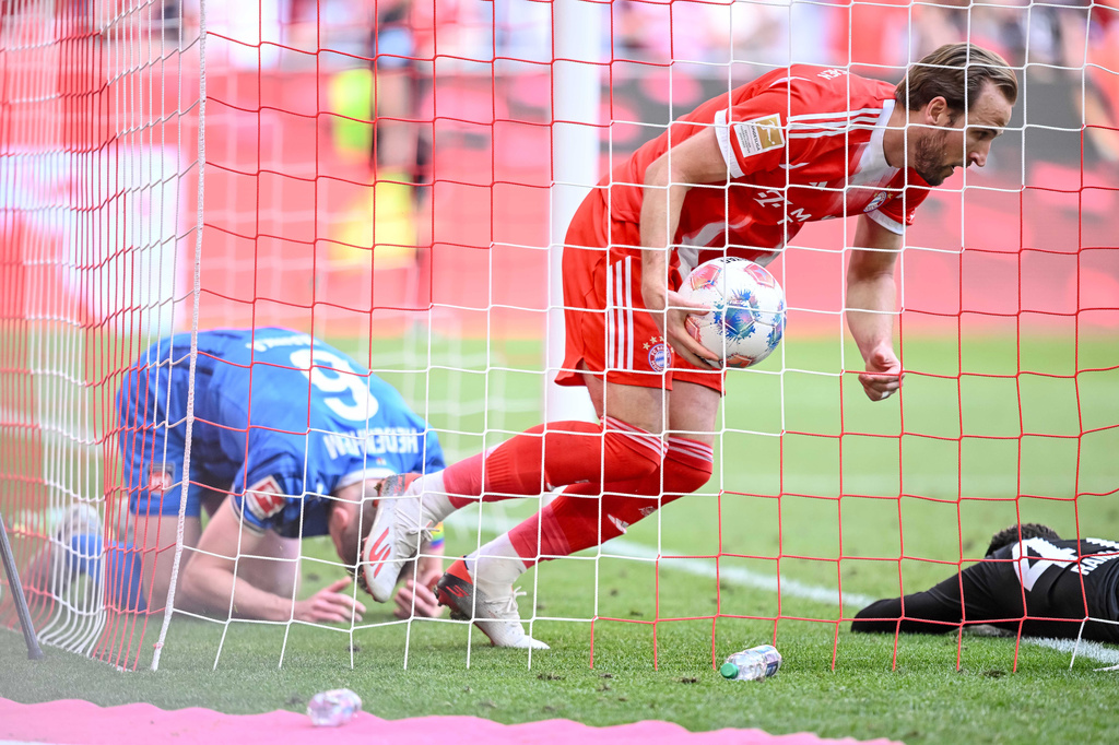 Bayern's Harry Kane retrieves the ball from the goal after the 3:3 during a German Bundesliga soccer match between Bayern Munich and 1. FC Heidenheim in Munich, Germany, Saturday, May 2, 2026. (Harry Langer/dpa via AP)