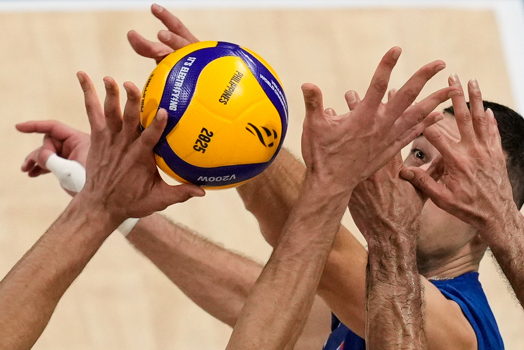 Pavle Peric of Serbia is blocked by Iran players during a round of 16 match at the 2025 FIVB Volleyball Men's World Championship at the Mall of Asia Arena in Pasay city, Philippines, Sept. 23, 2025. (AP Photo/Aaron Favila, File)