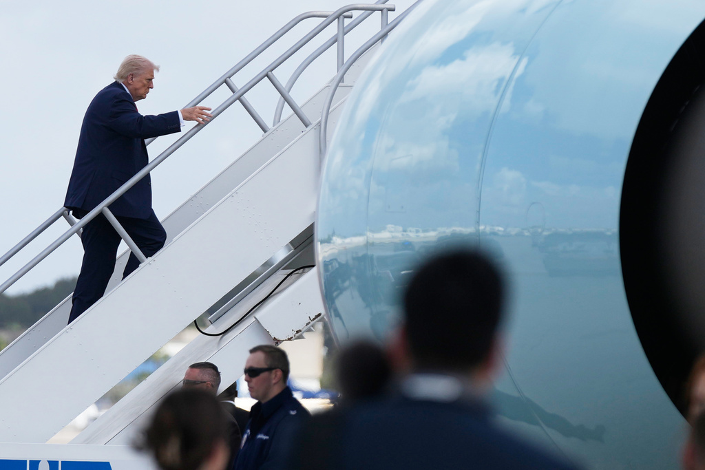 President Donald Trump boards Air Force One, Saturday, March 7, 2026, at Miami International Airport in Miami. (AP Photo/Mark Schiefelbein)