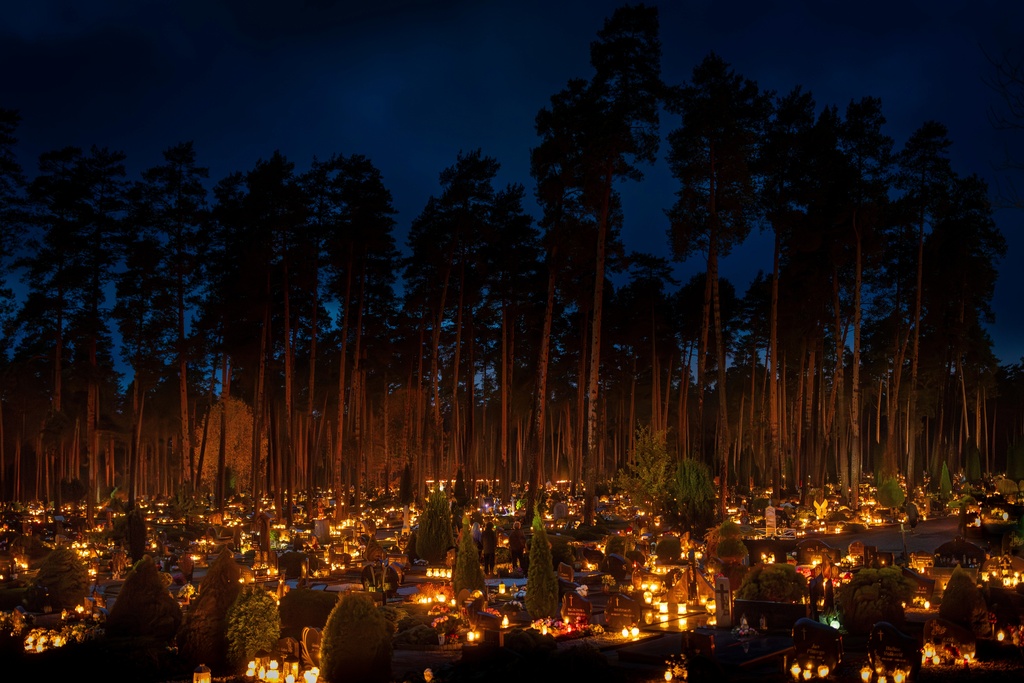 Candles are lit during All Saints Day at the cemetery in Vilnius, Lithuania, Saturday, Nov. 1, 2025. (AP Photo/Mindaugas Kulbis)
