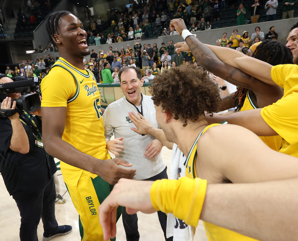 Baylor head coach Scott Drew, center, celebrates with his team after they defeated Utah earning him his 500th career win following an NCAA college basketball game, Saturday, March 7, 2026, in Waco Texas. (Rod Aydelotte/Waco Tribune-Herald via AP)