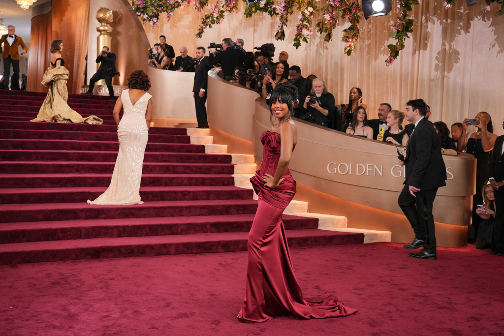 Maura Higgins, from ledt, Gayle King, and Mona Kosar Abdi arrive at the 83rd Golden Globes on Sunday, Jan. 11, 2026, at the Beverly Hilton in Beverly Hills, Calif. (Photo by Jordan Strauss/Invision/AP)
