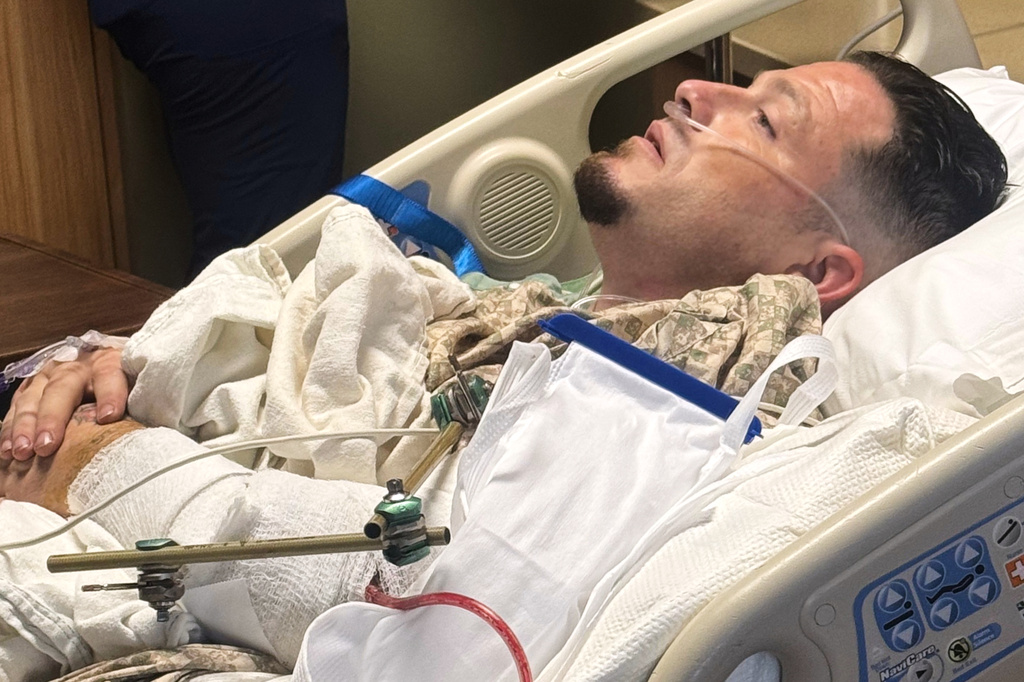 This photo provided by Tracey Evans shows Steven Pixley, who was injured in a shooting near an In-N-Out Burger restaurant, lying in a hospital bed at St. Luke's Magic Valley Medical Center in Twin Falls, Idaho, on Saturday, Aug. 1, 2026. (Tracey Evans via AP)