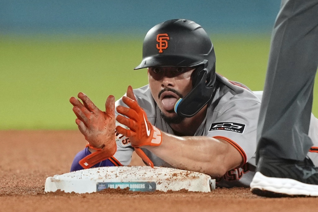 San Francisco Giants' Willy Adames claps after stealing second during the sixth inning of a baseball game against the Los Angeles Dodgers, Thursday, Sept. 18, 2025, in Los Angeles. (AP Photo/Mark J. Terrill)
