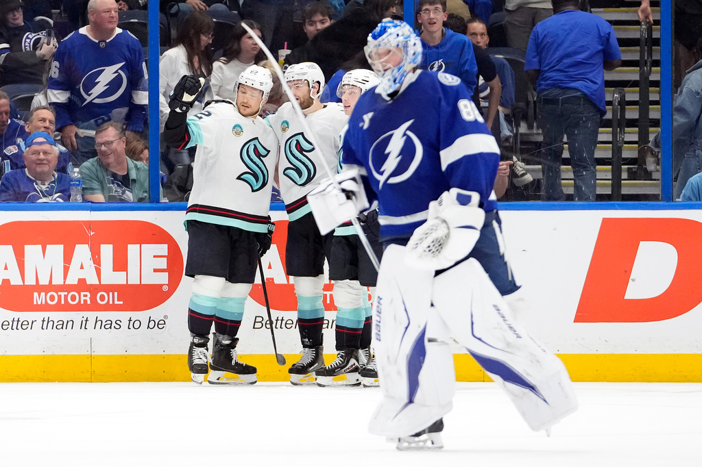 Seattle Kraken defenseman Brandon Montour, right, celebrates after scoring against Tampa Bay Lightning goaltender Andrei Vasilevskiy (88) during overtime of an NHL hockey game Thursday, March 26, 2026, in Tampa, Fla. (AP Photo/Chris O'Meara)