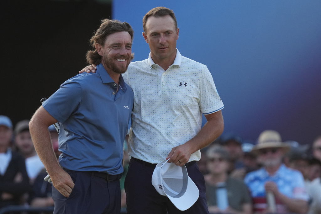 Tommy Fleetwood of England, left with Jordan Spieth of the United States on the 18th green after they completed their second rounds during the second day of the British Open Golf championships at Royal Birkdale golf club, in Southport, England, Friday, July 17, 2026. (AP Photo/Jon Super)