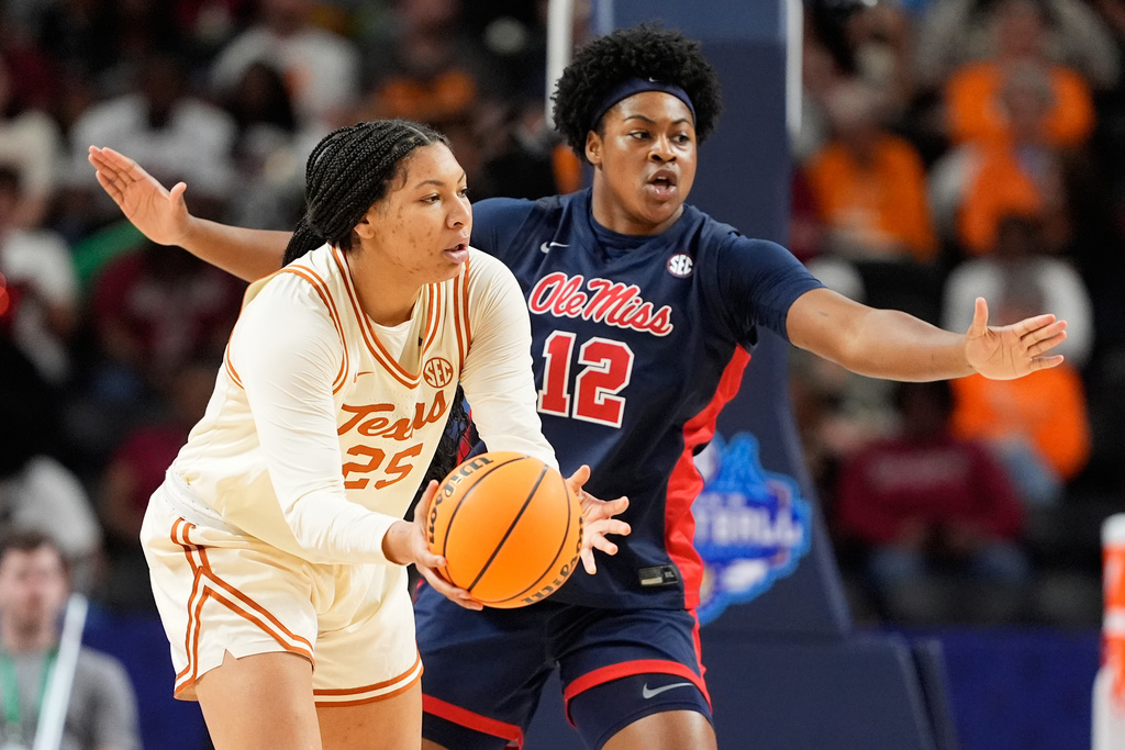 Texas forward Breya Cunningham passes around Mississippi forward Christeen Iwuala during the first half of an NCAA college basketball game in the semifinals of the Southeastern Conference tournament, Saturday, March 7, 2026, in Greenville, S.C. (AP Photo/Chris Carlson)